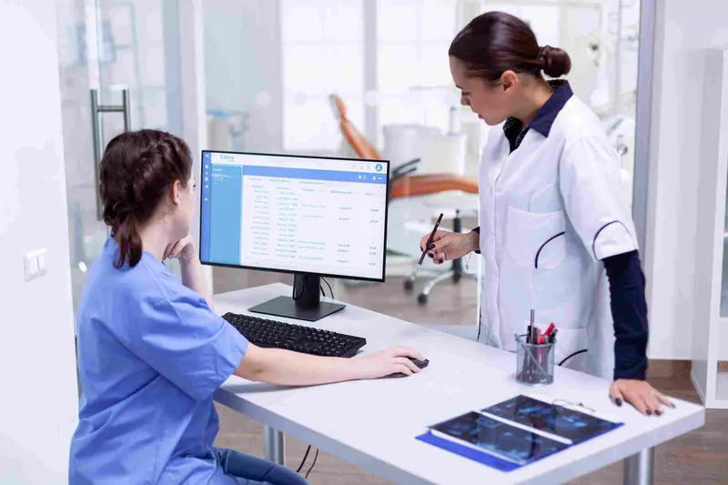 Nurse and doctor working with hospital management software