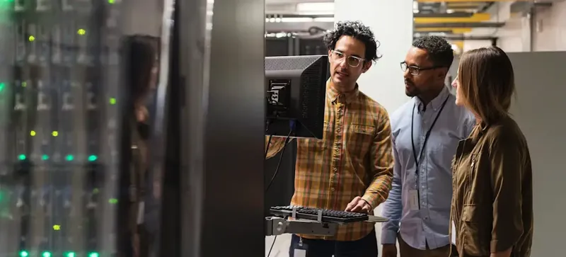 Engineers reviewing a machine learning workload in a server room